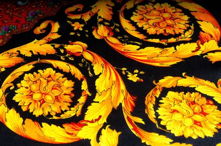 Background texture, drawing. Silk fabric. Fabric with bright patterns of yellow and red colors, Indian fabric, silk fabric around the yard, printed silk, printed fabric Sanganeryの写真素材