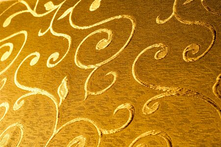 Texture, background, pattern. Damask fabric with shiny patterns on a matte background .. Golden...
