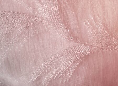 Texture, background, pattern. Tulle of pastel pink tones. Abstract background of pink fabric. Soft texture of the fabric, pink pastel tone. Shabby chic style. Crumpled tulle as a background.の写真素材