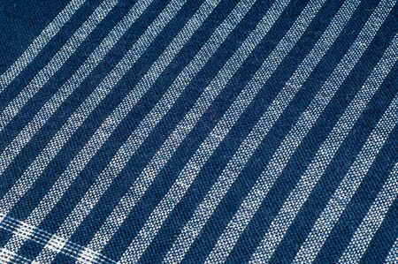 Texture, background, pattern. A woman's headscarf is dark blue. Square pattern of white metal fabric