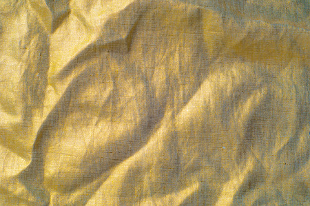 Background texture, pattern. Dense cotton fabric with gold color. Stop the presses! We at Mood just received the coolest material in the world  an outstanding Browned Gold Color Reflective Fabric.の写真素材