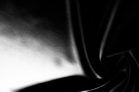 Texture, background, pattern. Black silk fabric.Pure Silk Charmeuse Crepe Backed Satin in BLACK fabric. Wide Stretch Silk Charmeuse Black By the Yardの写真素材