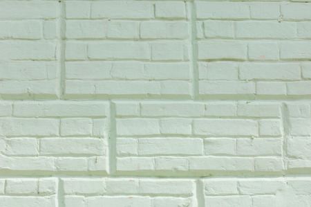 Texture, background, pattern. The brick is laid out decoratively. Brickwork, painted. Old brick wall with white and blue brick background. Ancient brick wallの写真素材