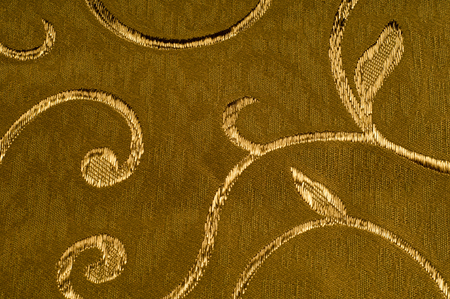 Texture, background, pattern. Damask fabric with shiny patterns on a matte background .. Golden color.  Abstract pattern. Luxury golden wallpaper. Vintage wave patternの写真素材