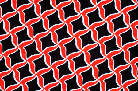 Texture, background, pattern. Fabric drawing of a diamond diamond red on a black background
