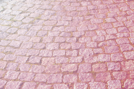 Texture, background, pattern. Granite covering. The texture of the stone pavement. Granite paved with cobblestone. Abstract background of old cobblestone close-up.の写真素材