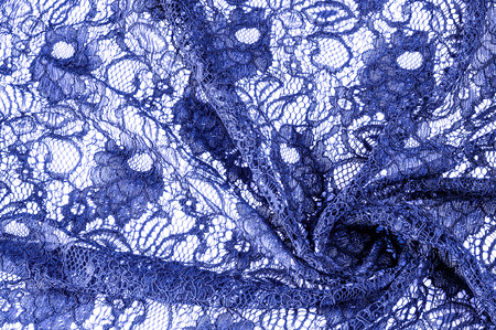 Texture, background, pattern. Cloth of blue lace. Background of fabric from lace stylized roses. Abstract lace pattern with flowers. Wallpaper, underwear and jewelry. Your invitationsの写真素材