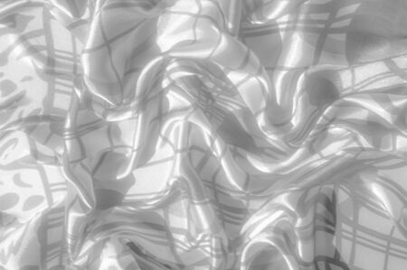 blurred. Background texture Silk. The fabric is white in color from steel, aluminum, titanium,...
