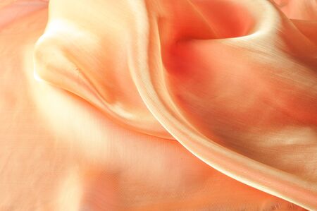 Texture, background, pattern. Orange Silk Fabric for Drapery Abstract Background. Abstract Fabric Flame Background, Artistic Waving Cloth Fractal Patternの写真素材