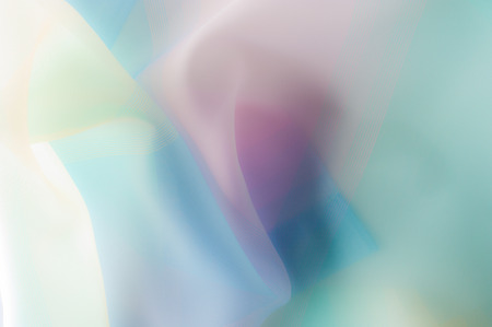 Blurry, not sharp sharpness Texture, background, pattern. Silk fabric is transparent, yellow-pink green in blue. Abstract soft chiffon texture background. の写真素材