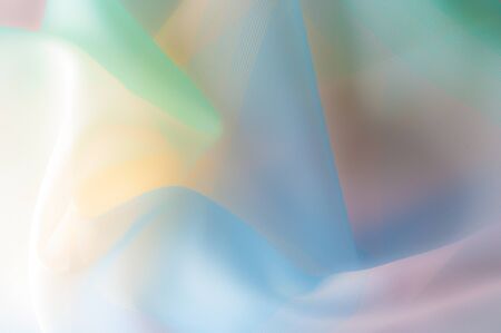 Blurry, not sharp sharpness Texture, background, pattern. Silk fabric is transparent, yellow-pink green in blue. Abstract soft chiffon texture background. の写真素材