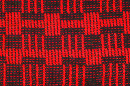 Texture, background, pattern. Soft warm cozy scarf in red cage