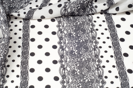 Texture, pattern, background. Cloth cotton. White fabric, painted with black polka dots, black lace....