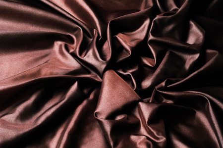Texture, background, pattern. Dark brown silk fabric. It is a dark brown brown, pure silk duoni. This is ideal for a beautiful scarf, clutch, tie, interior itemsの写真素材