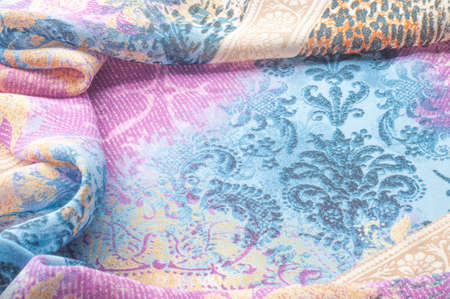 Texture background image, silk fabric, with abstract pattern. Blue, white, yellow, red. The folds of...