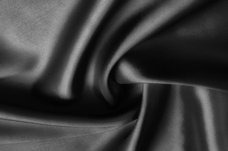 Soft focus cloth silk black. Take home this black washed silk! The washed black color is a soft, silky hand. Thin and light, it has a liquid drape that stands out when creating soft silhouettes.の写真素材
