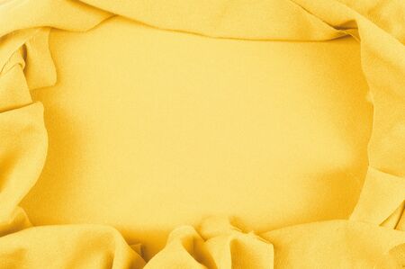 Texture, background, pattern. Yellow silk fabric.Smooth elegant golden silk can use as background. Golden satin textile background. の写真素材