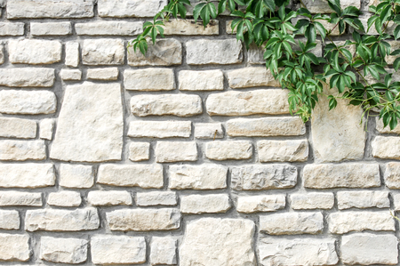 Texture background, pattern. The wall is stone. Architecture. Construction, house fencing. Sandstone cobblesの写真素材