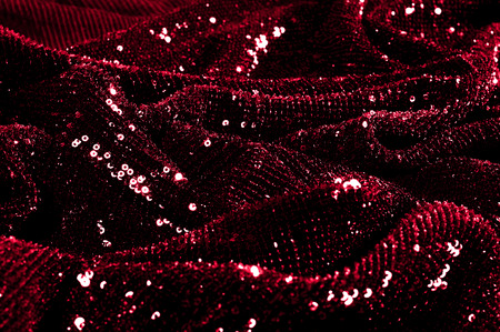 Texture, background, pattern, red fabric with paillettes. Look at these neon red sequins. Round neon pink sparkles glitter overlapping iridescent glitter on a clean purple grid.の写真素材