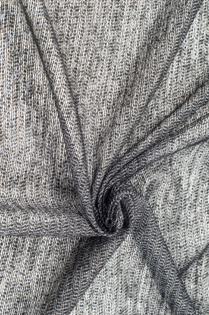 fabric gray black with white inserts metallic gold Thin white yarns are drawn on a black background, and thicker white yarns, twisted with a small amount of gold, create an almost spattered appearanceの写真素材