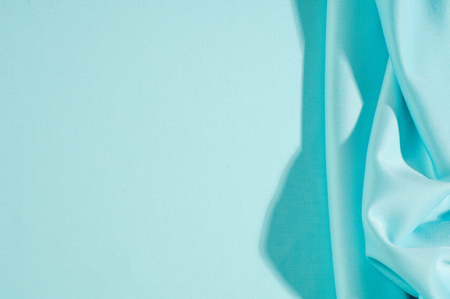 Texture. Background. Template. Pamper your design with a luxurious light blue silk flag. The blue dip can boast of a dull sheen and a crisp hand. His stiff drape creates volume when he falls.の写真素材