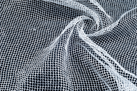 fabric, background texture. White silver mesh fabric, with a woven metallic thread. Silver fashion mesh! Flickering beads add texture and shine to the piece.の写真素材