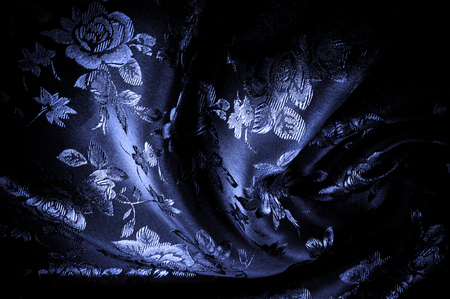 fabric, background texture. blue silky fabric with a pattern. Take the color lock to the next level with this black and purple floral printed silk.の写真素材