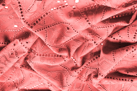 texture, pattern. Cloth red dense with perforated holes. Stop your search for perforated perfection with this army of red cloth! It contains fine drapery, flows well and has a lot of movement.の写真素材
