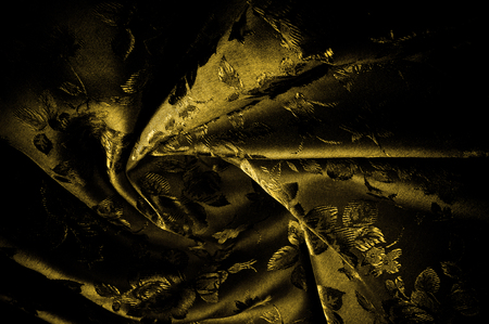 fabric, background texture. silk black and yellow fabric with a pattern. Celebrate engines and shakers with this brand-name silk fabric. Featuring a bohemian aesthetic tint,の写真素材