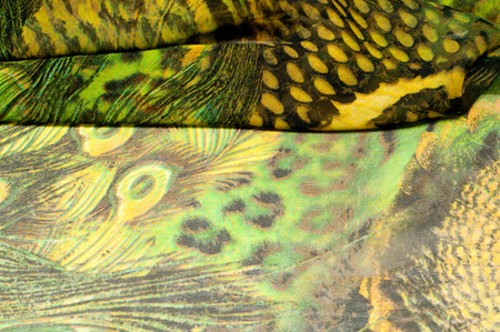 Background texture, drawing. Silk fabric. Light airy fabric. Green with peacock feathers. Yellow...