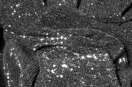 Black fabric with paillettes Make a dazzling debut  this Black Baby Sequined  The coating of the strength of the continuous mesh remains a dense arrangement of circular glitters for the entire coatingの写真素材