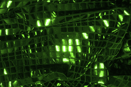 texture, background, pattern. Fabric with large paillettes made of green. Create a sharp look that is ready for attention with these multicolored oil stains of big sparkles.の写真素材