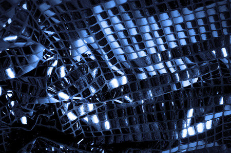 texture, background, pattern. Fabric with big sparkles of blue color. Show some style with these sporadic sparkles! Dispersed on a polyester mesh substrate, there are blue and white sequins,の写真素材