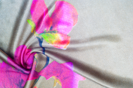 Background texture, pattern. silk fabric of gray color with a floral pattern. Rinse down the memory strip with this nostalgic, multicolored floral pattern with digital printing.の写真素材