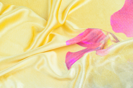 Background texture, pattern. silk fabric of yellow color with a floral pattern. Rinse down the memory strip with this nostalgic, multicolored floral pattern with digital printing.の写真素材