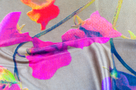 Background texture, pattern. silk fabric of gray color with a floral pattern. Rinse down the memory strip with this nostalgic, multicolored floral pattern with digital printing.の写真素材