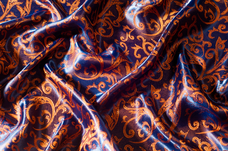 Texture, background, pattern. silk cloth Royal monogram. Moses Velvet with a design of gold foil lilies. Soft, light velvet depicts a playfully twirled design in decadent gold.の写真素材