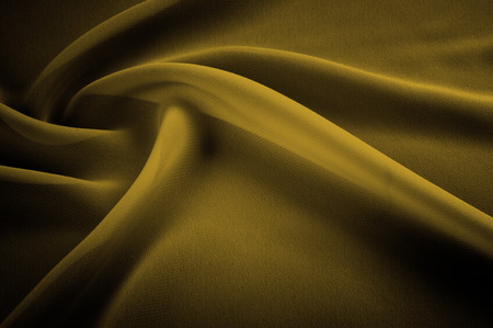 silk fabric is transparent, mustard, yellow. Chandeliers, light and abundant - all the characteristics of this fantastic fabric that you do not want to miss! Here we have a glamorous, light mustardの写真素材
