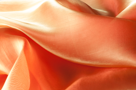 Texture, background, pattern. Orange Silk Fabric for Drapery Abstract Background. Abstract Fabric Flame Background, Artistic Waving Cloth Fractal Patternの写真素材