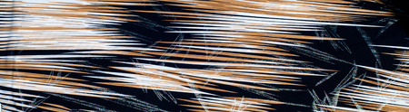texture of silk fabric. background. Yellow brown white stripes line. On a black background....