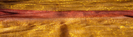 The texture of wool fabric yellow red golden. Women's scarf, the perfect backdrop.  cravat, neckerchief, kerchief, muffler, throw. a length or square of fabric worn around the neck or head.の写真素材