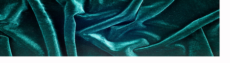 velor fabric texture, background, green. Velvet velor cloth background with glowing light and dark shadows. Background for theater and fashion design themes.の写真素材