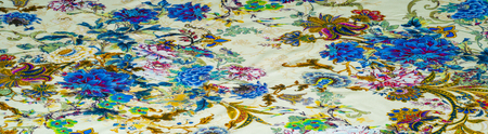 Texture, background, satin fabric beige color with a floral pattern. a smooth, glossy fabric,...