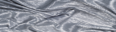 Silk fabric texture, background. Covered with sequins, silver colorの写真素材