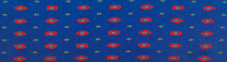 texture of the silk fabric with an abstract pattern, a pattern of tiny red quadrangles. 
