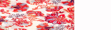 The texture of the silk fabric, red flowers on a white backgroundの写真素材