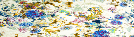 Texture, background, satin fabric beige color with a floral pattern. a smooth, glossy fabric,...
