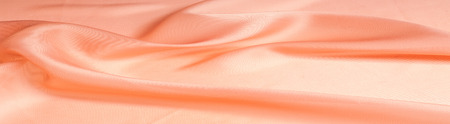 The texture of the silk fabric, soft pink.  rose-color, rose-colour, rose. Beautiful soft crumpled pink silk textureの写真素材