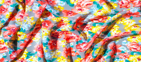 texture silk cloth. Yellow red flowers painted on cloth, abstract pattern. 