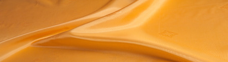 The texture of the silk fabric, painted with a brown pattern.  macro texture of brown striped fabric studio. Artistic fabric texture, folded, wavy. の写真素材